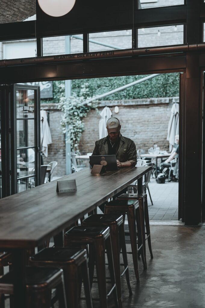 man in black jacket sitting on chair near table man cave garden cabin