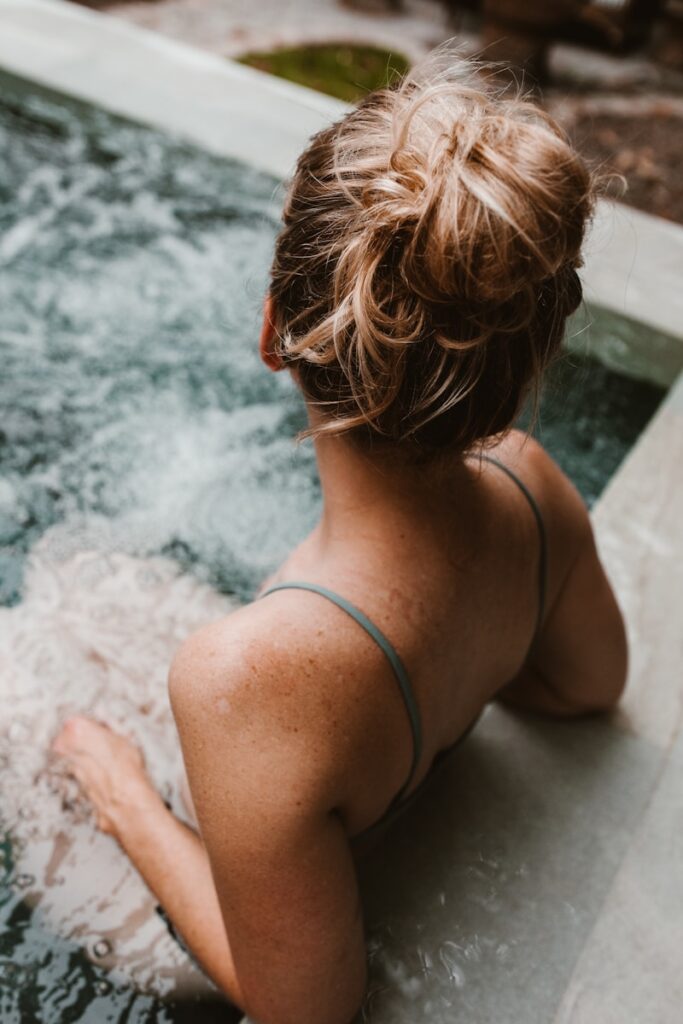 woman in hot tub - garden trend on the out for 2026 - hot tubs